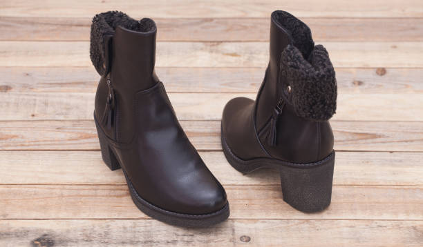 istock Boots with fur lining at wood background 1094639354