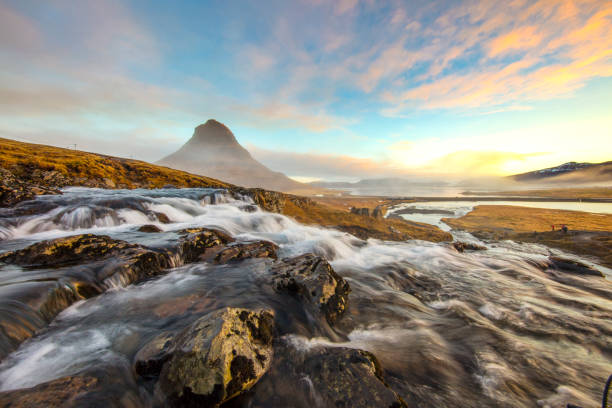 Kirkjufell mountain and Kirkjufellsfoss,Sneafellsness, Iceland Kirkjufell (Icelandic: Church mountain) is a 463 m high mountain on the north coast of Iceland's Snaefellsnes peninsula,near the town of Grundarfjordur. It is claimed to be the most photographed mountain in the country. kirkjufell stock pictures, royalty-free photos & images