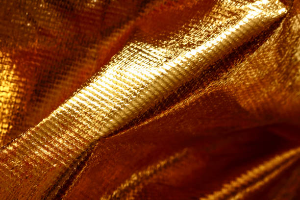 istock Close up view of gold coloured cloth material 1094641826