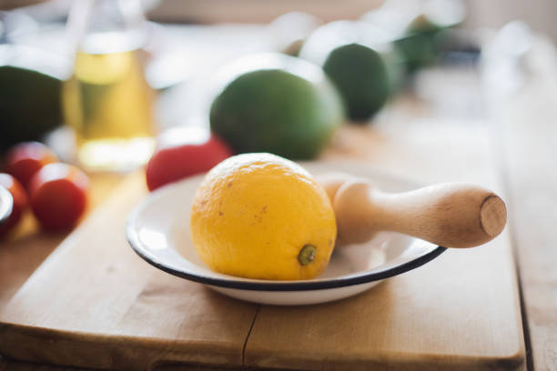 istock Lemon, avocado and cherry tomatoes at table, close-up 1094643802