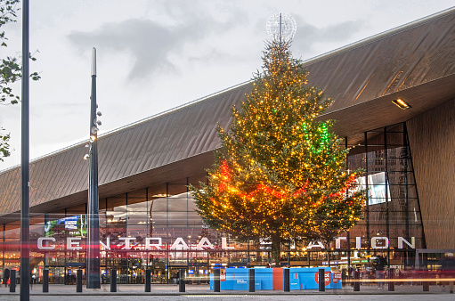 Rotterdam, The Netherlands, December 11, 2018: large christmas tree in front of the central railway station at dusk