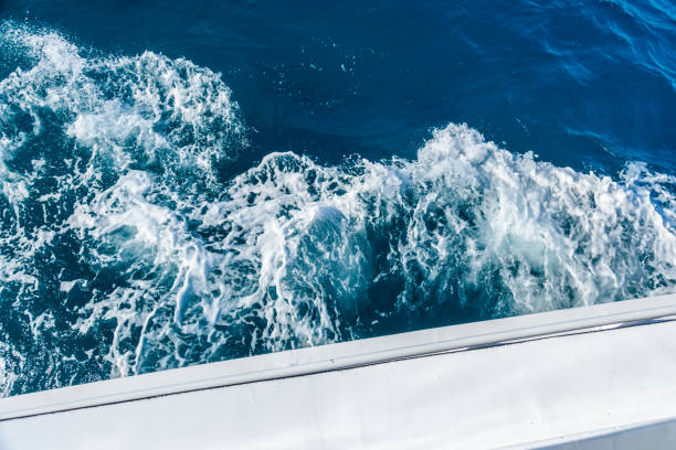 istock Wave trace with white foam on a water surface behind of fast moving yacht 1094645626