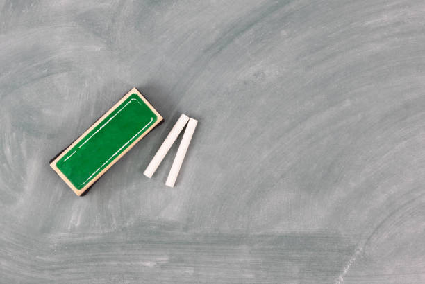 Back to school concept with green erased chalkboard and eraser plus chalk