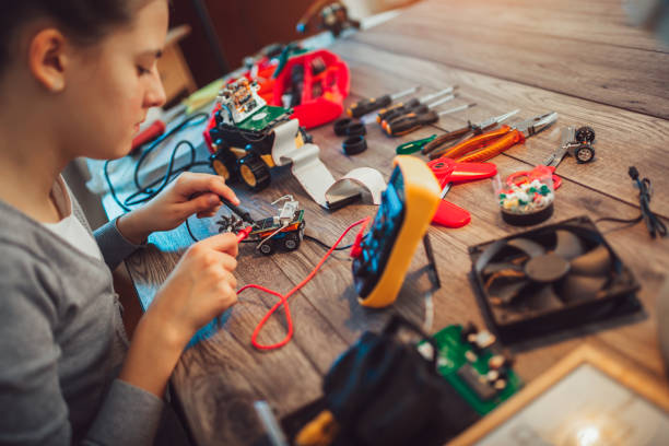 istock Girl constructs technical toy. Technical toy on table full of details 1094646002