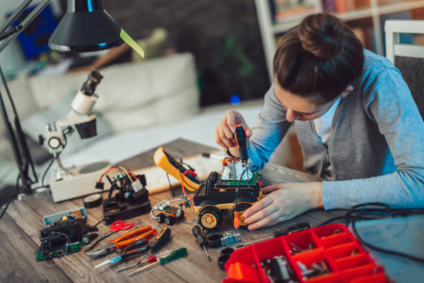 istock Girl constructs technical toy. Technical toy on table full of details 1094646132