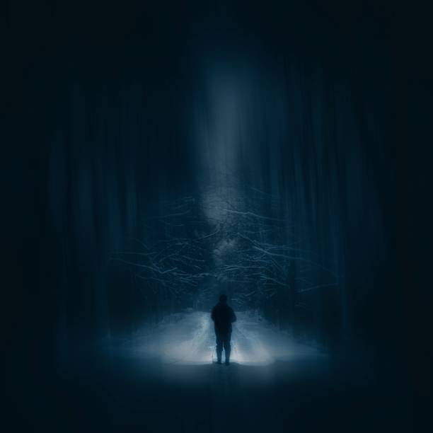 istock Surreal night forest landscape with alone strange man with flashlight. 1094649014
