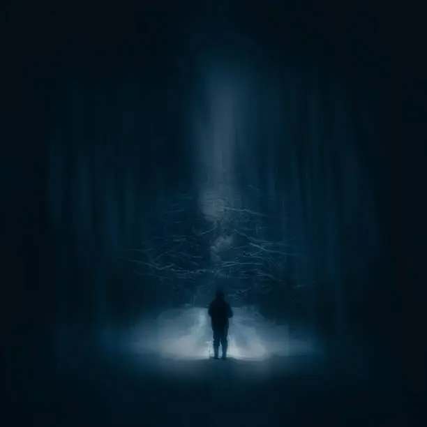 Photo of Surreal night forest landscape with alone strange man with flashlight.