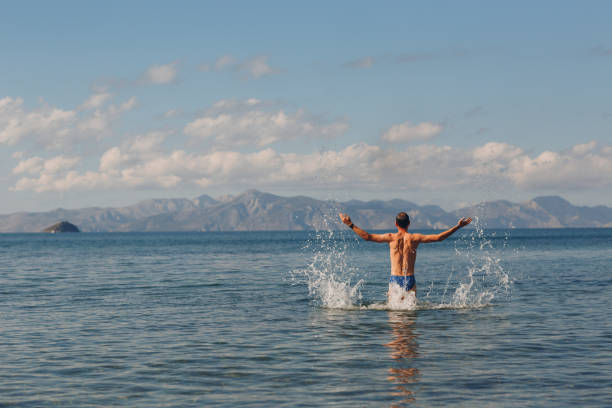 istock A young man jump in the sea 1094649490