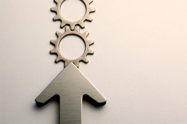 istock Arrow Pushes A Row Of Interlocking Gears 1094650960