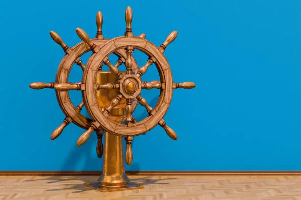 Ship's wheel or boat's wheel in room on the wooden floor, 3D rendering