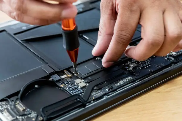 Photo of technician repairing the HDD of a laptop