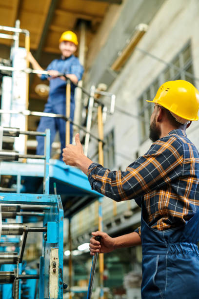 istock Teamwork at production industry: middle-eastern worker with beard showing thumb-up to colleague while they exchanging information about process 1094663146