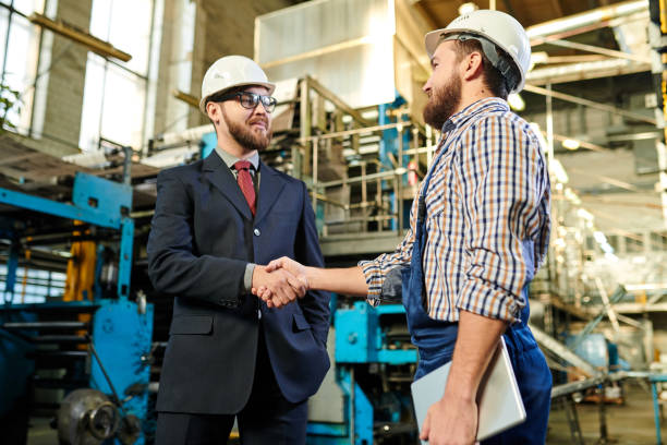 istock Content young industrial engineer with tablet making handshake with new investor after concluding deal 1094666504