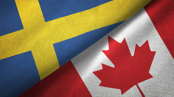 istock Canada and Sweden two flags together textile cloth fabric texture 1094668134
