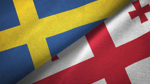 istock Georgia and Sweden two flags together textile cloth fabric texture 1094668378