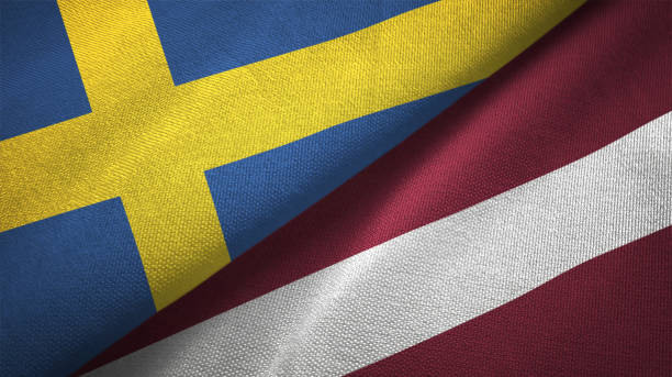 istock Latvia and Sweden two flags together textile cloth fabric texture 1094668502