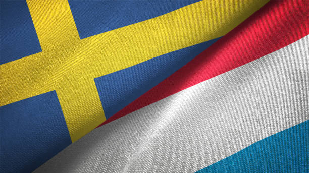 istock Luxembourg and Sweden two flags together textile cloth fabric texture 1094668618