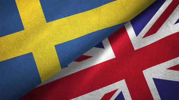 Photo of United Kingdom and Sweden two flags together textile cloth fabric texture