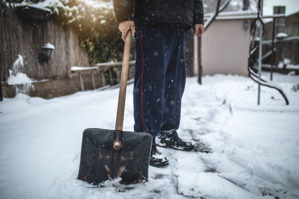 istock Senior man with a snow shovel 1094669898