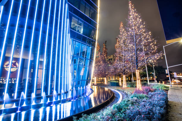 istock Close-up of corporate building facade and lit tree at night 1094674706