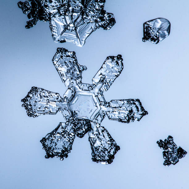 istock Beautiful snow flake on a light blue background close up 1094676970