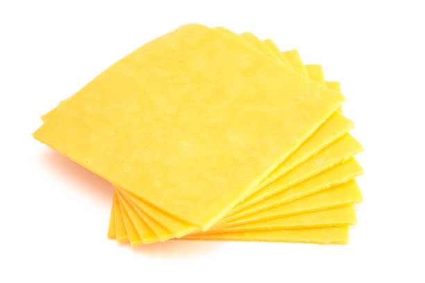 Slices of Cheddar Sandwich Cheese on a White Background