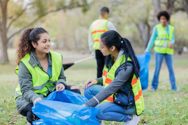 istock Two female community cleanup volunteers enjoy conversation 1094681464