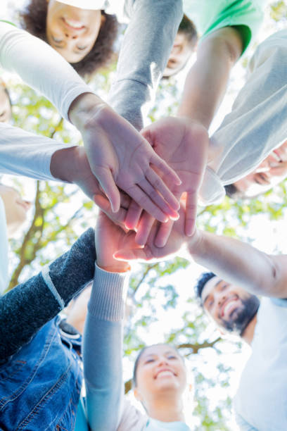 istock View from below of group of volunteers stacking hands 1094681482
