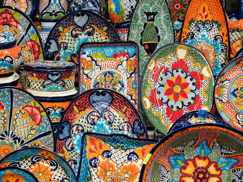 Colourful traditional pottery on sale at street market and souvenir shop in San Miguel de Allende, Guanajuato, Mexico.