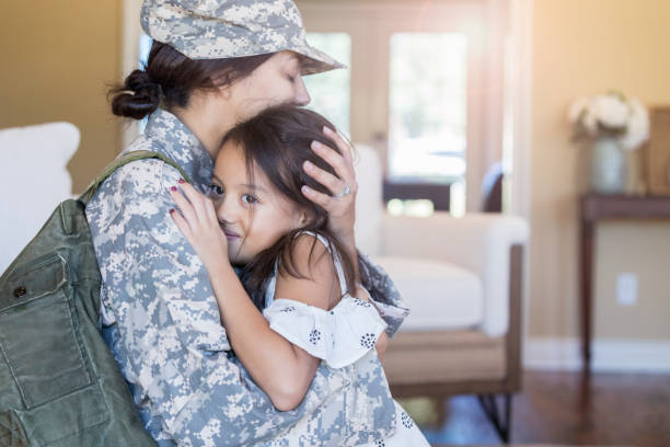 istock Sad female soldier hugs young daughter 1094681712