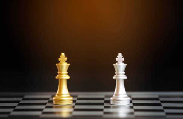 istock chess pieces on chessboard with black background 1094682516
