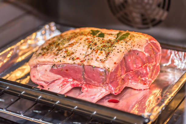 istock closeup view raw beef cross rib chunk on oven tray with foil inside oven 1094682686