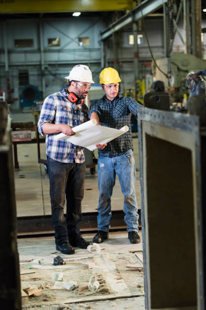 istock Multi-ethnic workers talking in metal fabrication plant 1094686844