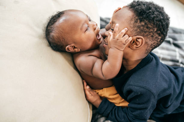 Siblings playing together Brother and little baby sibling stock pictures, royalty-free photos & images