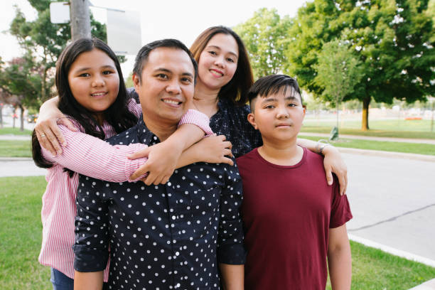 istock Smiling parents with two kids 1094695528