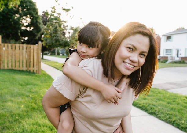 istock Smiling mom with daughter outdoor 1094695538