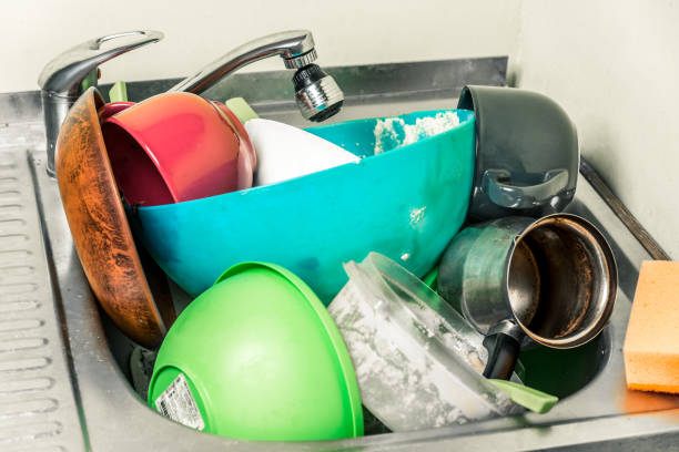 istock dirty dishes, cups, plates, spoons in the sink 1094706844