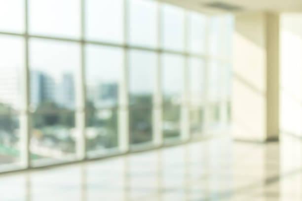 istock Blur background interior view looking out toward to empty office lobby and entrance doors and glass curtain wall 1094706992