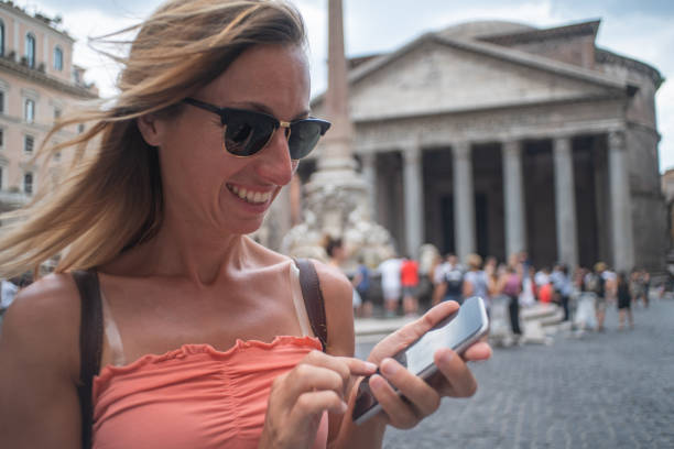 istock Woman text messaging on mobile phone, Pantheon, Rome, Italy 1094710824