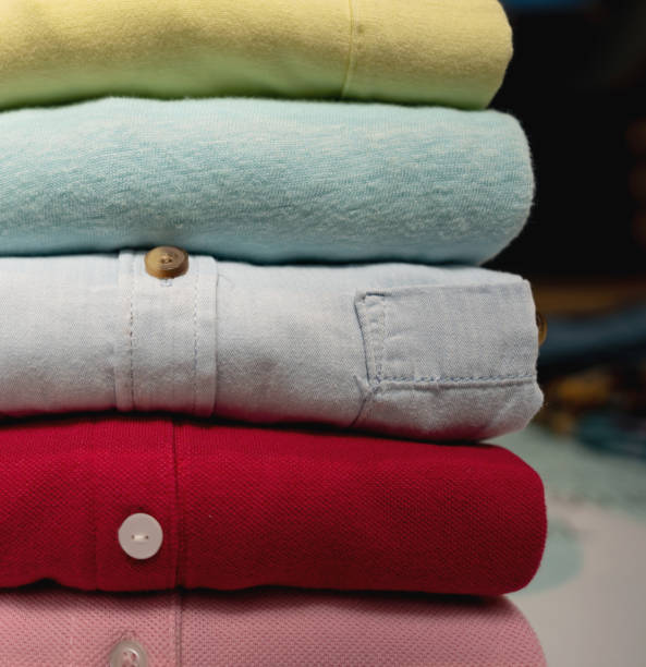 close up of rolled colorful clothes on red background