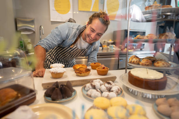 istock Friendly waiter looking at the desserts smiling 1094713502