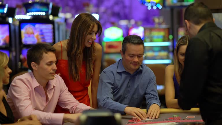 Group of latin american players at the blackjack table looking focused