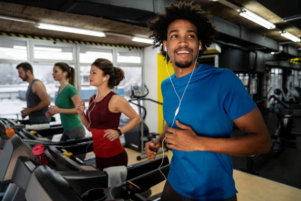 People running on a treadmill in health club People running on a treadmill in health club people in a row photos stock pictures, royalty-free photos & images