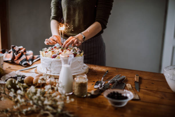istock Woman Adding Sprinkles to Delicious Birthday Cake 1094716282