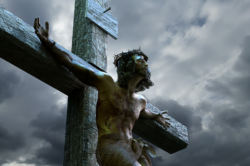 Jesus Christ figurine on a tombstone at the public cemetery