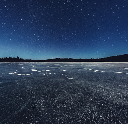 Moonlit clear skies above a vast frozen lake in Northern Nova Scotia.  Long exposure.