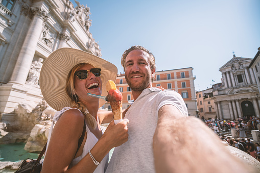 Couple in Rome taking selfie with gelato
