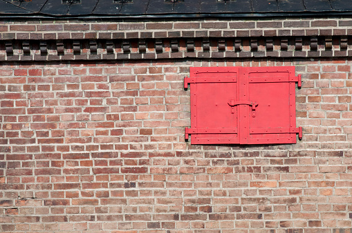 Brick warehouse with red iron door