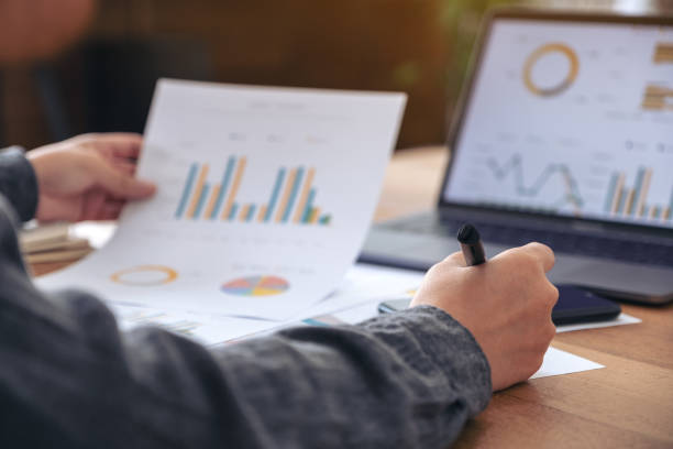 istock A businesswoman writing and working on business data and document 1094730502