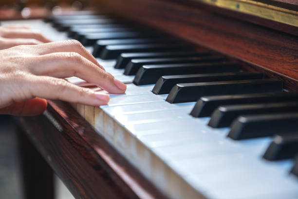 istock ands playing a vintage wooden grand piano 1094730558